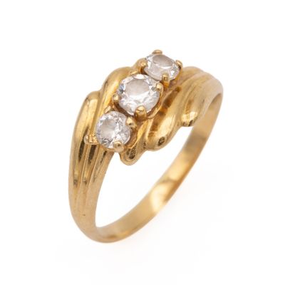 a close up of a gold ring with three diamonds on it