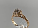 an image of a gold and diamond ring on a clear surface