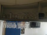 many glasses hanging from the ceiling above a bar