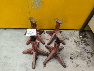 four wooden chairs sitting on the floor next to a yellow wall