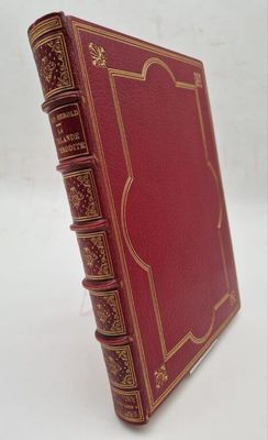an old red book sitting on top of a table next to a white wall