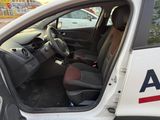 a white van with the door open and the driver ' s seat up