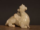 a small statue of a dragon sitting on a table