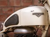a close up of a motorcycle with a brick wall in the background