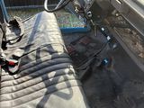 a car that is sitting in the grass with a steering wheel