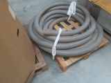 a pile of hoses sitting on a pallet in a warehouse