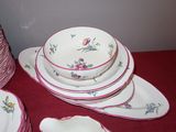 a lot of plates and bowls sitting on a table