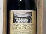 a bottle of wine in a wooden box on a table