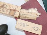 two boxes of matches and a pair of shoes on a table