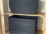 a wooden shelf with several trays on top of it