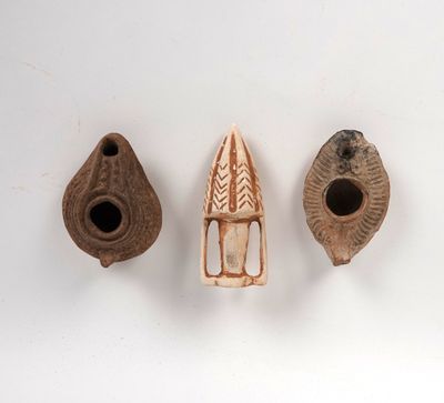 three pieces of pottery are sitting next to each other on a white surface