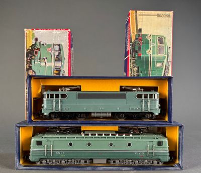 two green trains sitting in a box on a table
