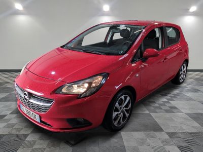 a red car parked in a garage with a checkered floor