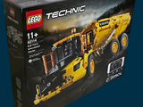 a box of lego technic construction equipment on a blue background