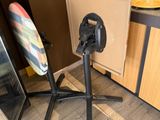 a surfboard sitting on a tripod next to a table