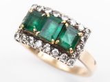 an image of a close up of a ring with three emerald stones