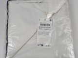 the white blanket is wrapped in plastic and ready to be used
