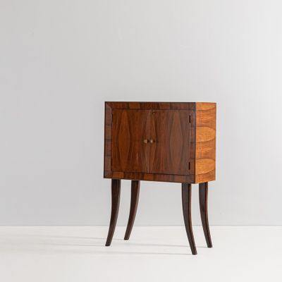 a small wooden cabinet with two drawers and two legs