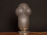 a glass lamp that is sitting on a wooden table