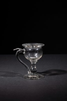 a glass cup that is sitting on a table