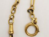 a close up of a gold chain with a clasp on it