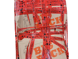 a package wrapped in red and white paper with a red ribbon