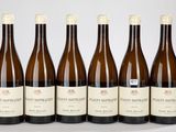 six bouteilles de vin sont alignées sur une table