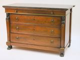 a wooden chest of drawers with a marble top