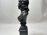 a black bust of a man with a hat on top of it