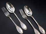 three silver spoons and a fork on a black surface