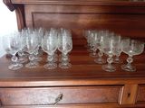 a lot of wine glasses sitting on top of a dresser