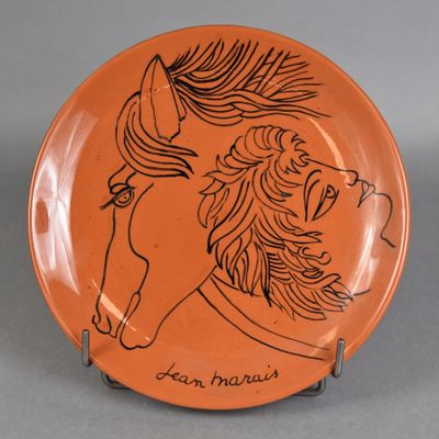 an orange plate with a drawing of a horse on it