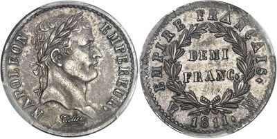 a silver coin with a woman ' s face and laurels on it