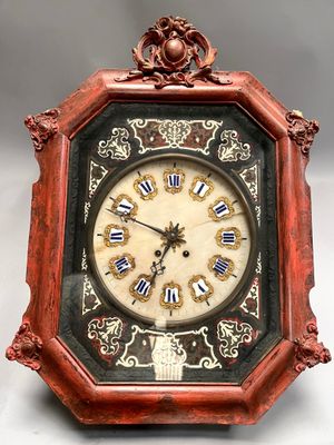 a clock that is sitting on a white surface