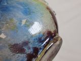 a close up of a vase with a blue and green design on it