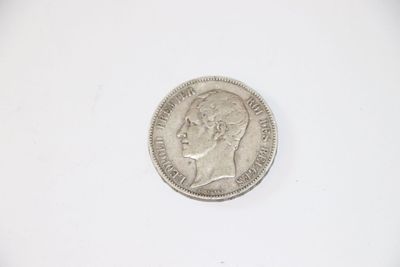 a close up of a coin on a white surface with a white background