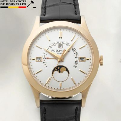 a gold wrist watch with a white dial and a black leather strap