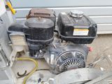 two air compressors sitting next to each other on the ground