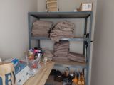 a shelf that has a lot of towels and bottles on it