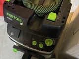 a black and green corded vacuum and a black and green hose
