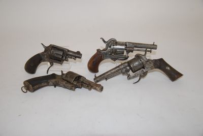 three old revolvers are sitting on a table with a white background
