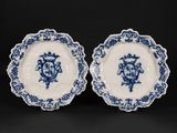 a pair of blue and white plates with floral designs on them