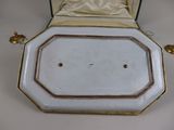 a white and gold plate with a gold border on it