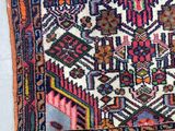 a close up of a rug on a white surface with a blue background