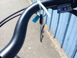 a close up of a bicycle handlebar with a key attached to it