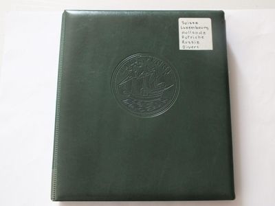 a close up of a green book on a white surface