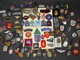 many different types of military badges on a table