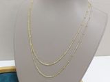 the necklace is sitting on a display case with other jewelry