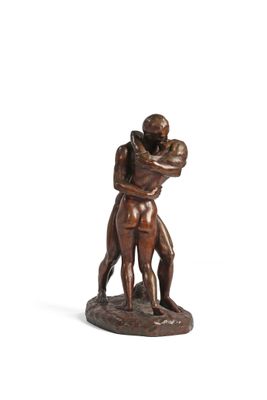 statue of a man and woman hugging each other on a white surface