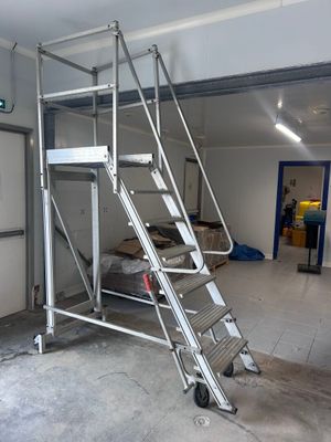 une photo d'une échelle dans un garage dont la porte est ouverte